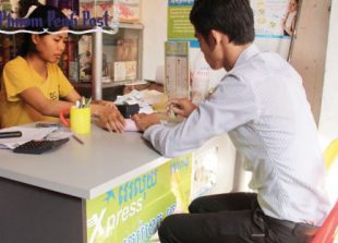 business_a_wing_representative_assists_a_customer_at_a_local_branch_in_phnom_penh_vireak_mai