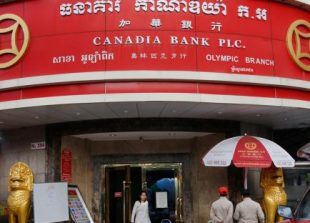 business_customers_walk_out_of_a_canadia_bank_branch_in_phnom_penh_last_month_pha_lina