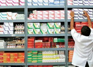 business-an-indian-pharmacist-pulls-out-a-box-of-medicines-from-a-shelf-at-a-drug-store-in-bangalore_manjunath-kiran_afp