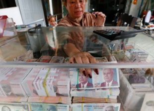 business_a_woman_arrages_cambodian_riel_currency_at_an_exchange_store_in_phnom_penh_pha_lina
