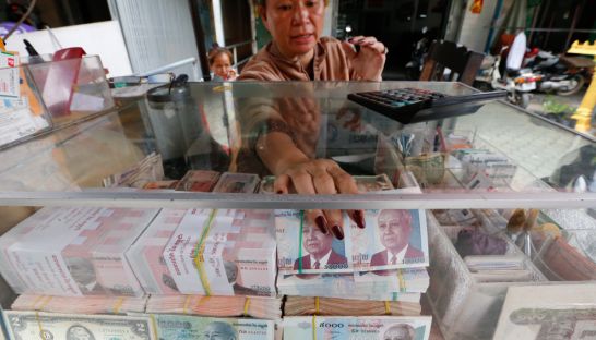 business_a_woman_arrages_cambodian_riel_currency_at_an_exchange_store_in_phnom_penh_pha_lina