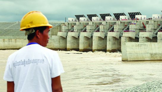 business_a_worker_stands_in_front_of_the_lower_sesan_ii_dam_as_it_was_went_inline_in_september_in_stung_treng_province_25_09_2017_hong_menea