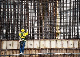 A construction worker stands at a building site in Kuala Lumpur on August 12, 2016.
Malaysias economic growth eased in the second quarter, the central bank said on August 12, attributing the slowdown to a decline in exports amid subdued global demand. / AFP PHOTO / MOHD RASFAN