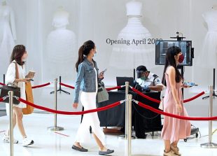 Shoppers passing by a temperature scanner at the entrance of Pavilion KL during the Recovery Movement Control Order. AZMAN GHANI / The Star