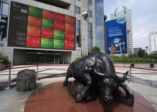 A statue of a bull stands in front of an electronic board displaying stock prices outside the Indonesia Stock Exchange (IDX) in Jakarta, Indonesia, on Thursday, April 18, 2019. With Indonesian President Joko Widodo on course to win a second term as leader, the political uncertainty that's weighed on the economy this year will be lifted. Photographer: Dimas Ardian/Bloomberg