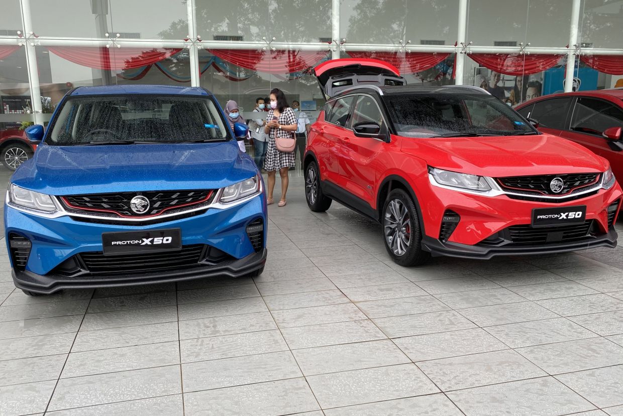 Customers having a close look at the newly launched Proton X50 during the CMCO at Rahman Brothers showroom in Shah Alam yesterday. — IZZRAFIQ ALIAS/The Star