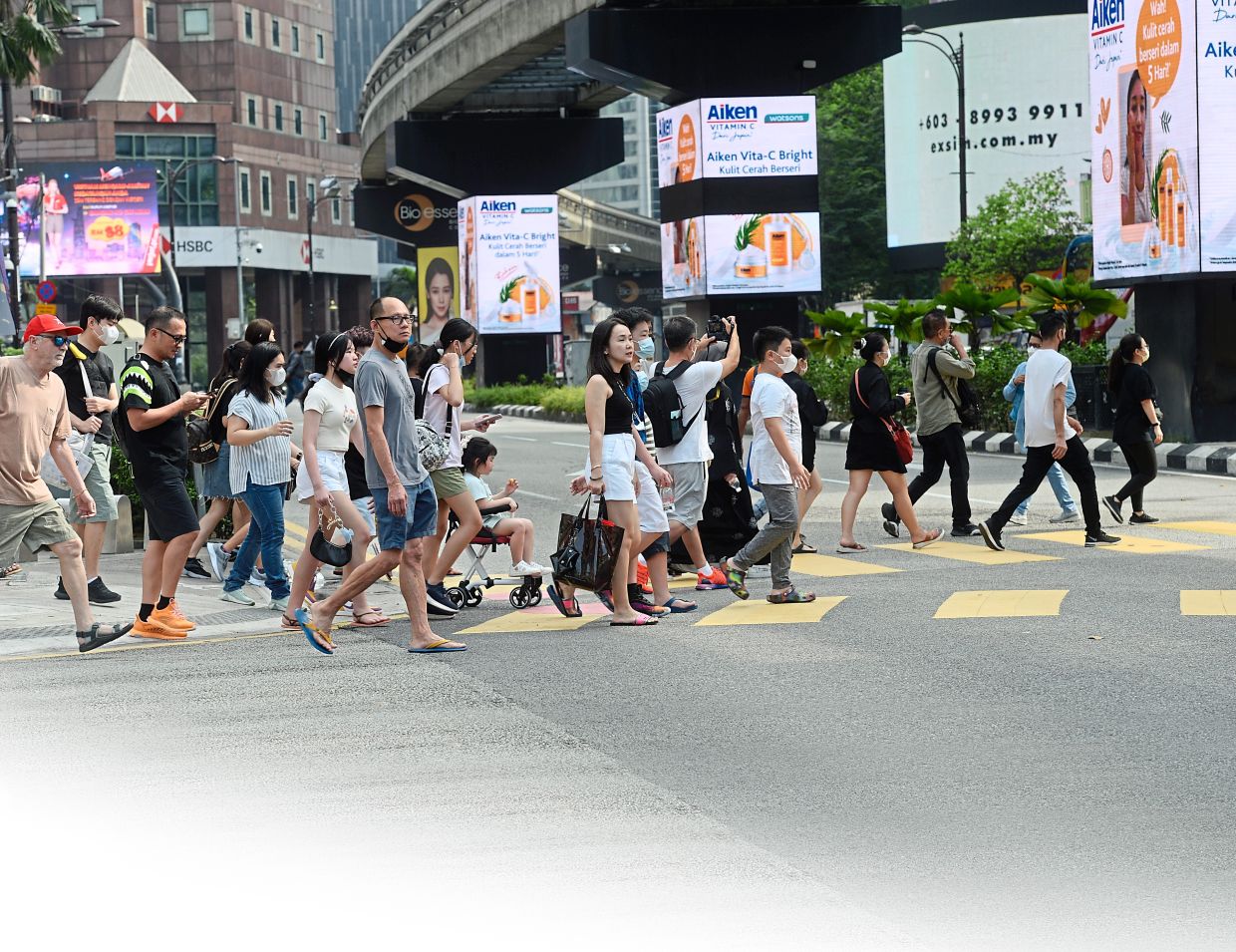 Tourist crossing the road easily without any traffic due to Hari raya haji at jalan Bukit Bintang  in  Kuala Lumpur (08/07/2022/ S.S.Kanesan/The Star)