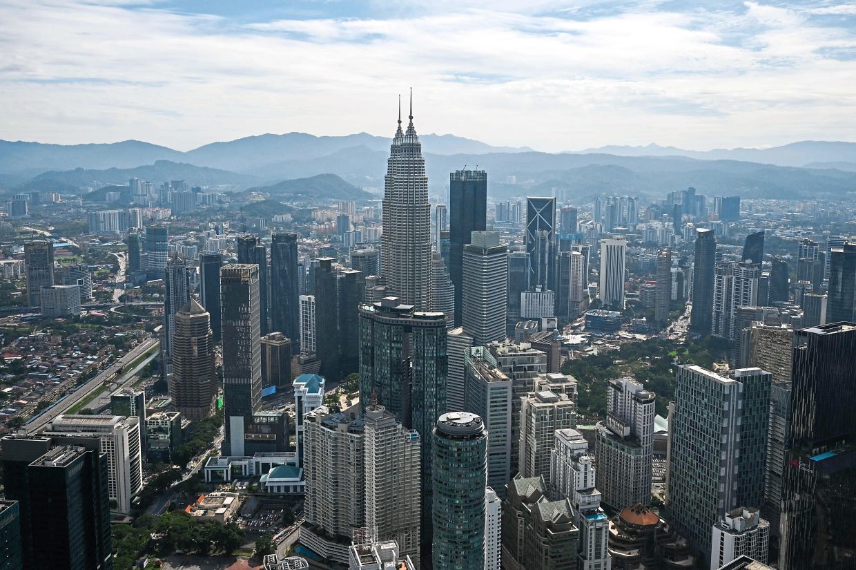 A general view shows the Petronas Twin Towers (C) and other commercial buildings as seen from KL Tower in Kuala Lumpur on September 8, 2022. (Photo by Mohd RASFAN / AFP)