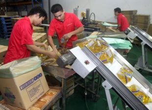 Workers  packing cooking oil at a factory in Klang.
AZHAR MAHFOF/The Star
